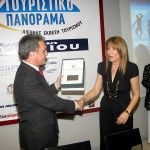 Matoula Belegri, president of the Lakonia prefecture tourism committee, accepts the honorary award on behalf of Lakonia Prefect Konstantinos Foukas from Yiorgos Kalofolias.