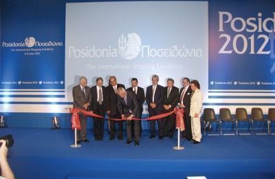 Caretaker Prime Minister Panagiotis Pikrammenos cuts the ribbon during the official opening ceremony of the 23rd Posidonia International Shipping Exhibition.