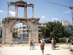 Tourists seen at the monumental gateway of Hadrian's arch in the center of Athens. Upon releasing data on bookings in the Greek capital, the Athens-Attica Hotel Association recently referred to “a depressing performance of the destination and its hotels.”