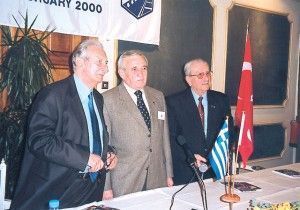 Skal Club Turkey President Halit Cura, , and National Committee Skal Clubs Greece President Spyros Katehis (Skal Club Rodos). At the podium, Athens member Michael Coveas of the International Skal Council.