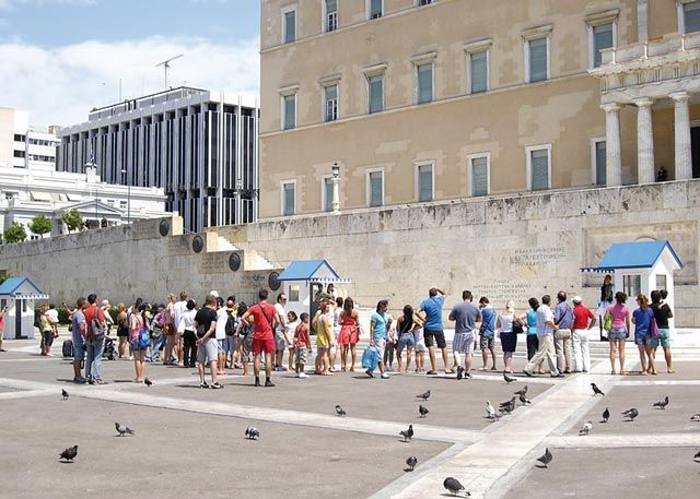 Tourists gathered in front of the Parliament building on Syntagma Square and wait to watch the Changing of the Guard ceremony at the Tomb of the Unknown Soldier in central Athens. According to the Tourism Ministry, the city’s tourism development will include a strategy that will extend to neighborhoods throughout the city and not be not limited to the historic center.
