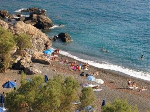 Platys Gialos - An unorganized and highly popular beach with impressive rocks and black sand.