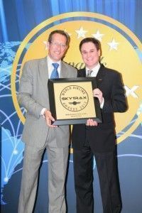 Peter Baumgartner, Etihad Airways' Chief Commercial Officer, receives one of the SKYTRAX First Class category awards from CNN's Richard Quest.