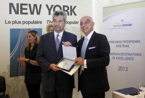 Marathon Mayor Iordanis Loizos accepts an award from Greek Tourism Ministry Secretary General Tasos Liaskos.