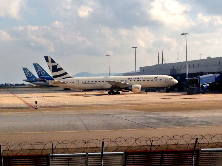 SkyGreece aircraft next to Α340 Αirbus of Olympic at Athens International Airport.