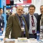 Hellenic American Chamber of Tourism (HACT) President George Trivizas, Miraz Tours Manager Marios Trivizas and Andy's Tours Vice President & Managing Director Evan Vasileidis at the stand of the General Panhellenic Federation of Tourism Enterprises (GEPOET).