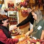 GNTO general secretary Angela Varela sampling cold cuts from Lefkada at the Polychronopoulos Delicatessen stand.