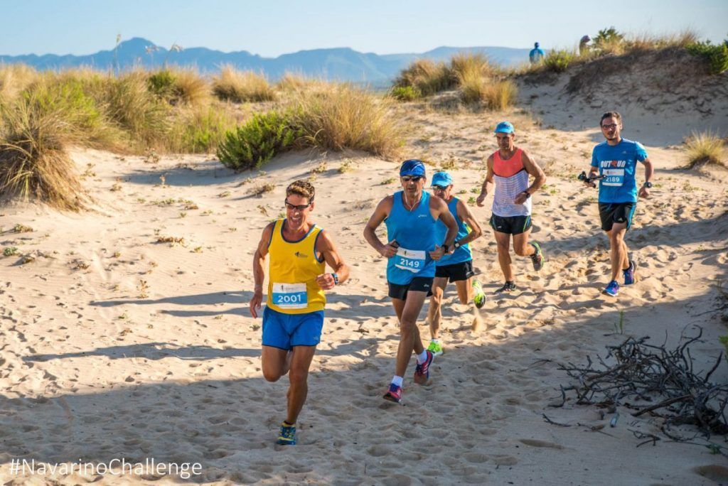 Dean Karnazes and the participant runners of Navarino Challenge crossing Voidokilia beach (photo credit: Elias Lefas).