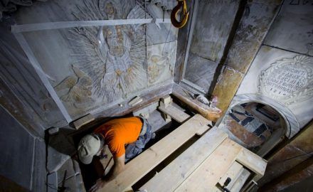 A conservator cleans the surface of the stone slab venerated as the final resting place of Jesus Christ. Photo source: National Geographic, Photograph by Oded Balilty, AP