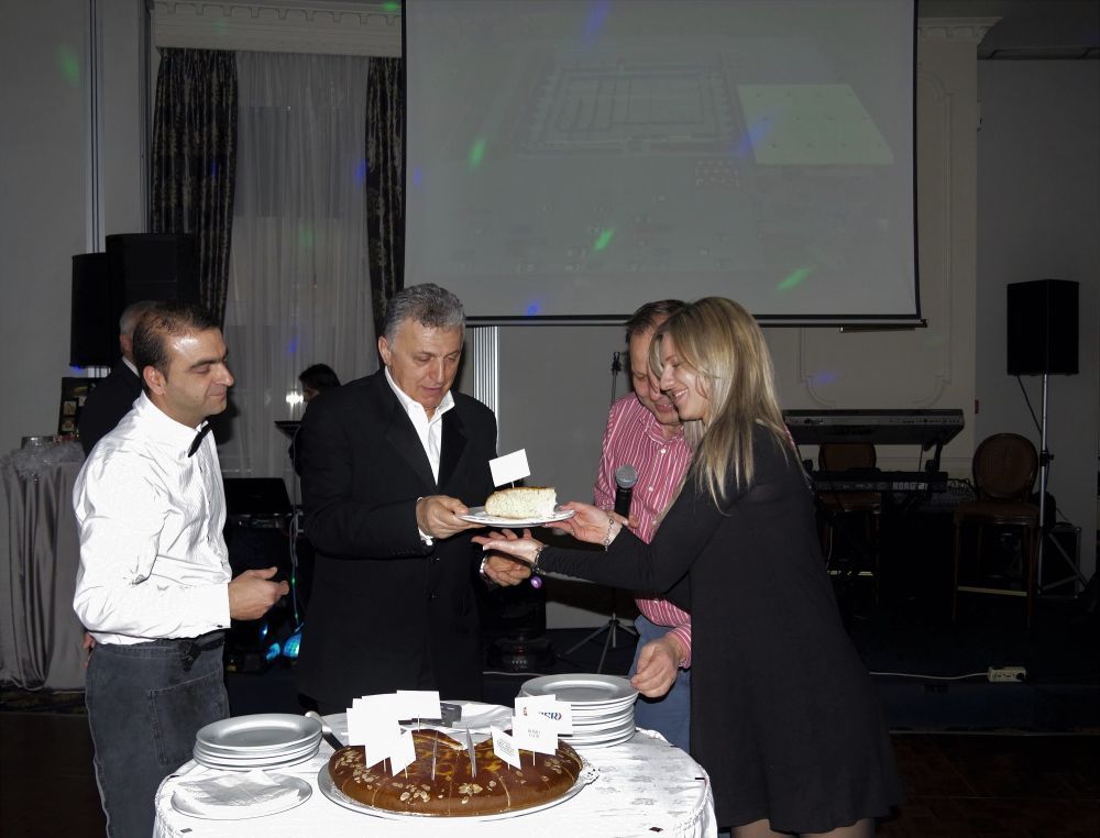 Mouzenidis Group President Boris Mouzenidis cutting the traditional New Year's ''vassilopita'' cake.