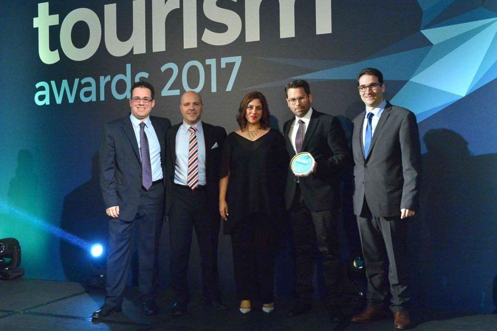 Aqua Vista Hotels' assistant director of sales, Alexander Dardoufas; director of sales, Yiorgos Tsolakakis; business development manager, Sophia Matzouranis; and the architect and owner of the Kassandra Bay, Leonidas Bays, receiving the Gold Award in the "eco-friendly Hotel/Resort" category for the environmental policy and sustainability system implemented by the hotel from Ioannis Dimopoulos, managing director of ekdromi.gr.