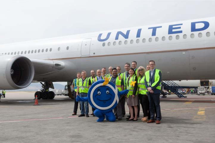 United team and Athens airport mascot, “Philos the Athenian”, in front of the Boeing 767-400ER at Athens International Airport.
