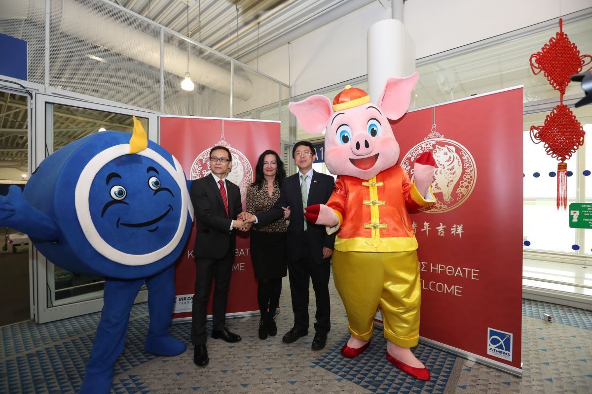 “Philos the Athenian”, AIA's mascot; Fan Heyun, General Manager, Athens Office, Air China; Ioanna Papadopoulou, AIA Director, Communications & Marketing; Wang Qiang, Counsellor & Deputy Head of Mission, Embassy of the People’s Republic of China; and «Zhū lèlè», the mascot for the Chinese New Year.