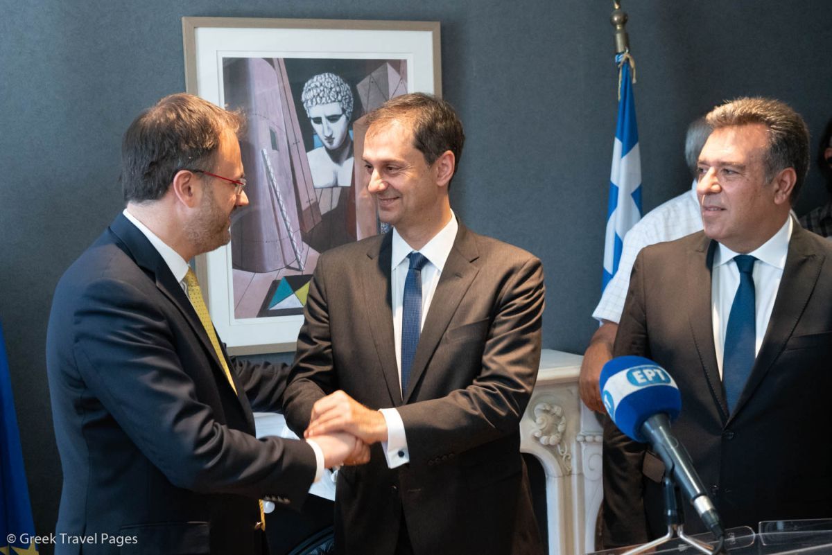 New Greek Tourism Minister Harry Theoharis (right) congratulating Outgoing Tourism Minister Thanasis Theocharopoulos for a "job well done".