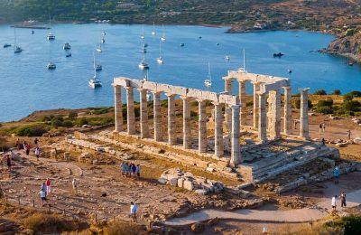 Aerial view of the beach and Temple of Poseidon at Cape Sounion at the edge of Attica, Greece, during summer sunset time. Photo source: Visit Greece