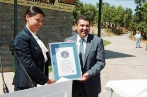 Grevena Prefect Dimosthenis Kouptsidis shows off the official certificate from Guinness World Records that certifies that the two record-breaking mastodon tusks found by palaeontologists at Milia, Grevena are the longest ever found.