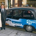 Sofia Vasiliou, GNTO's general director of promotion; and Makis Peppas, GNTO director for the U.K. & Ireland, next to a taxi cab in London parked outside GNTO London offices. The cab displays part of the organization's advertising campaign in an effort to attract British visitors to Greece.