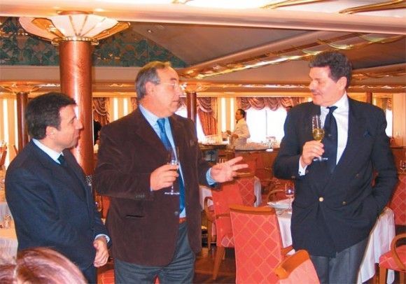 Andreas Stylianopoulos of Navigator Travel with unidentified collaborator, and Aris Zarpanely, executive vice president of Silversea Cruises as they toast to cruise vessels under construction.