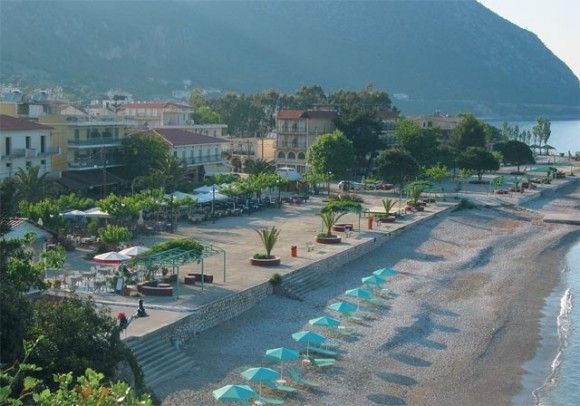 Poros town's central square and white pebble beach.