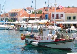 Fiskardo's colorful buildings and boat-filled harbor.