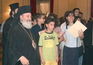 Archbishop Christodoulos congratulating a student and teacher from the Avgoulea-Linardatou School of Peristeri in Attica.