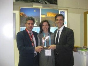 Pictured with the Golden City Gate award is Athens Convention Bureau Director, George Angelis; ATEDCo Public Relations Director Kalliopi Andriopoulou; and ATEDCo CEO Panagiotis Arkoumaneas.